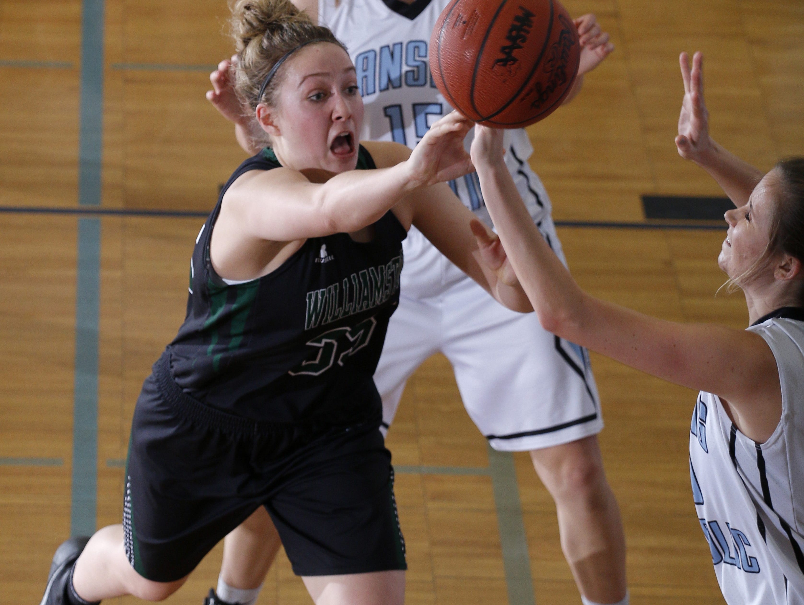 Williamston's Allison Peplowski, left, passes against pressure from Lansing Catholic's Chrissy Jurkovic, right, as Becka Poljan, rear, watches last season. Peplowski, the daughter of ex-MSU big man Mike Peplowski, is in her third season of the Hornets' varsity roster.
