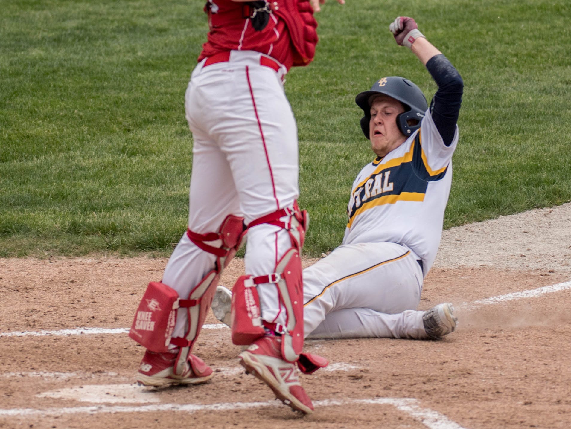 Battle Creek Central's Dallas Gillum slides into home during the Annual Play 4 May tribute game at C.O. Brown Stadium on Monday.