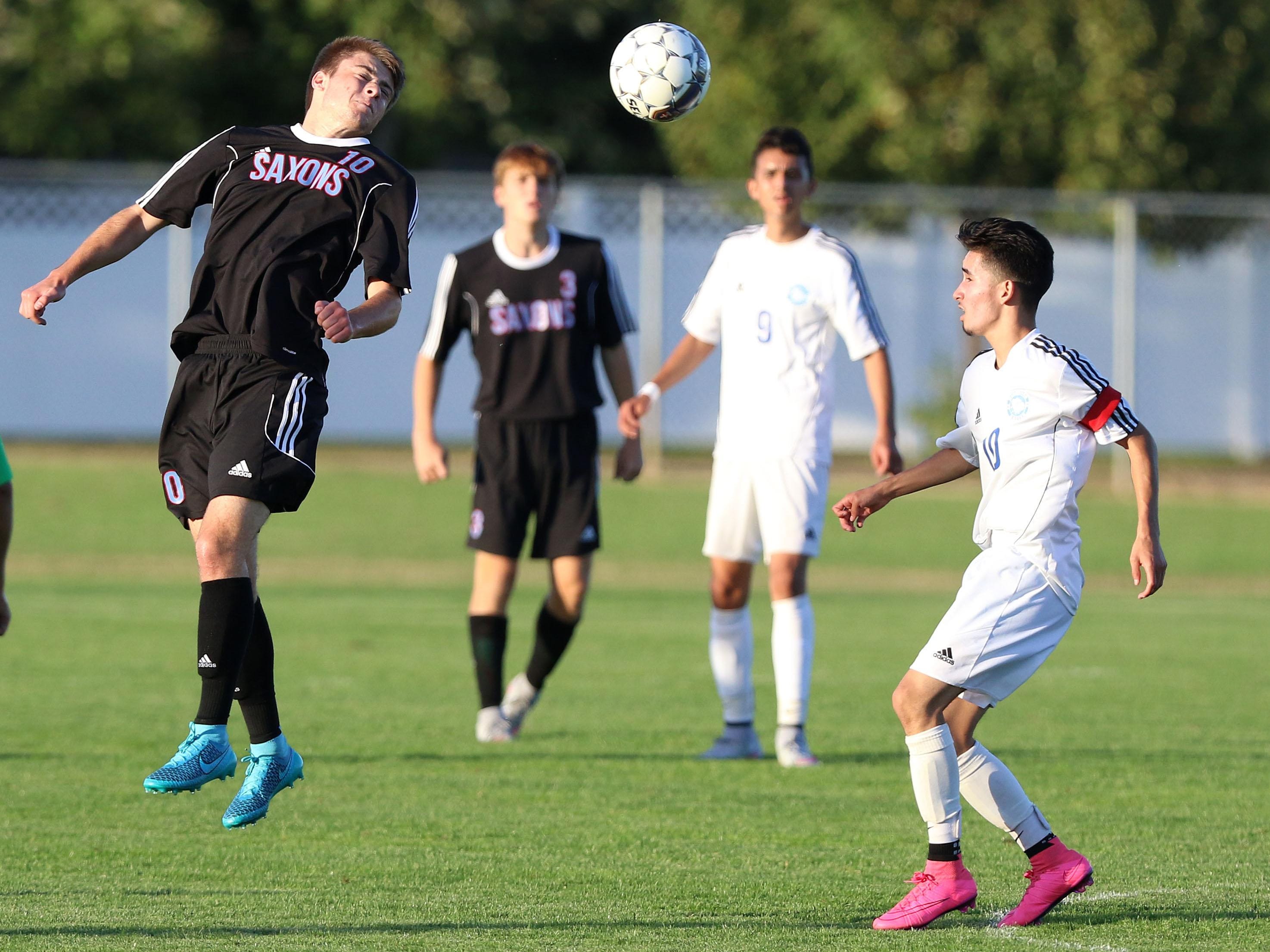 South Salem High School's Isaac Morris heads the ball during their game with Woodburn on Tuesday, Sept. 8, 2015, in Woodburn.