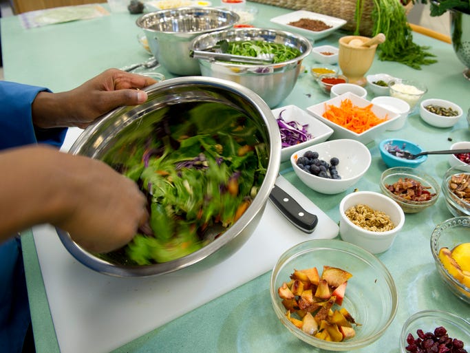 Culinary manager Angela Wadlington mixes up future salad concepts in The Bench Top area of Chick-fil-A's HQ.