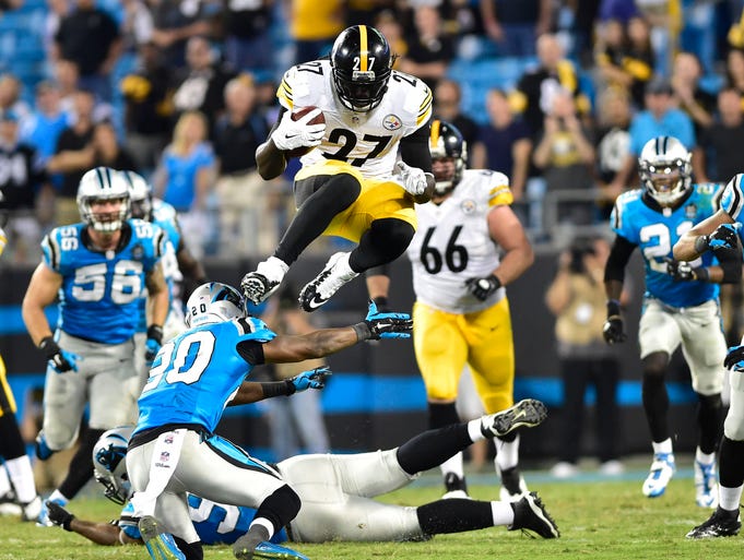 Steelers running back LeGarrette Blount (27) leaps over a Panthers defender on a fourth-quarter run.