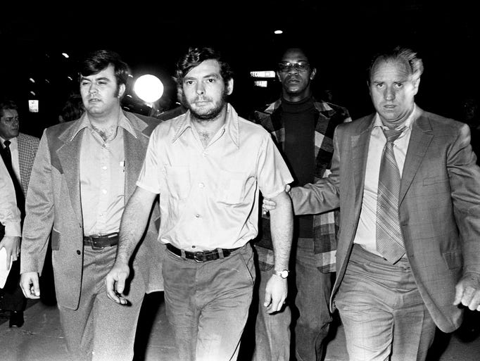 Metro detective Sgt. Sherman Nickens, right, escorts Douglas Brown, 21, of Greenbrier to the detective division Nov. 14, 1973. Brown, along with his brother, Roy, was interrogated for several hours about the murders of David "Stringbean" Akeman and his wife, Estelle.