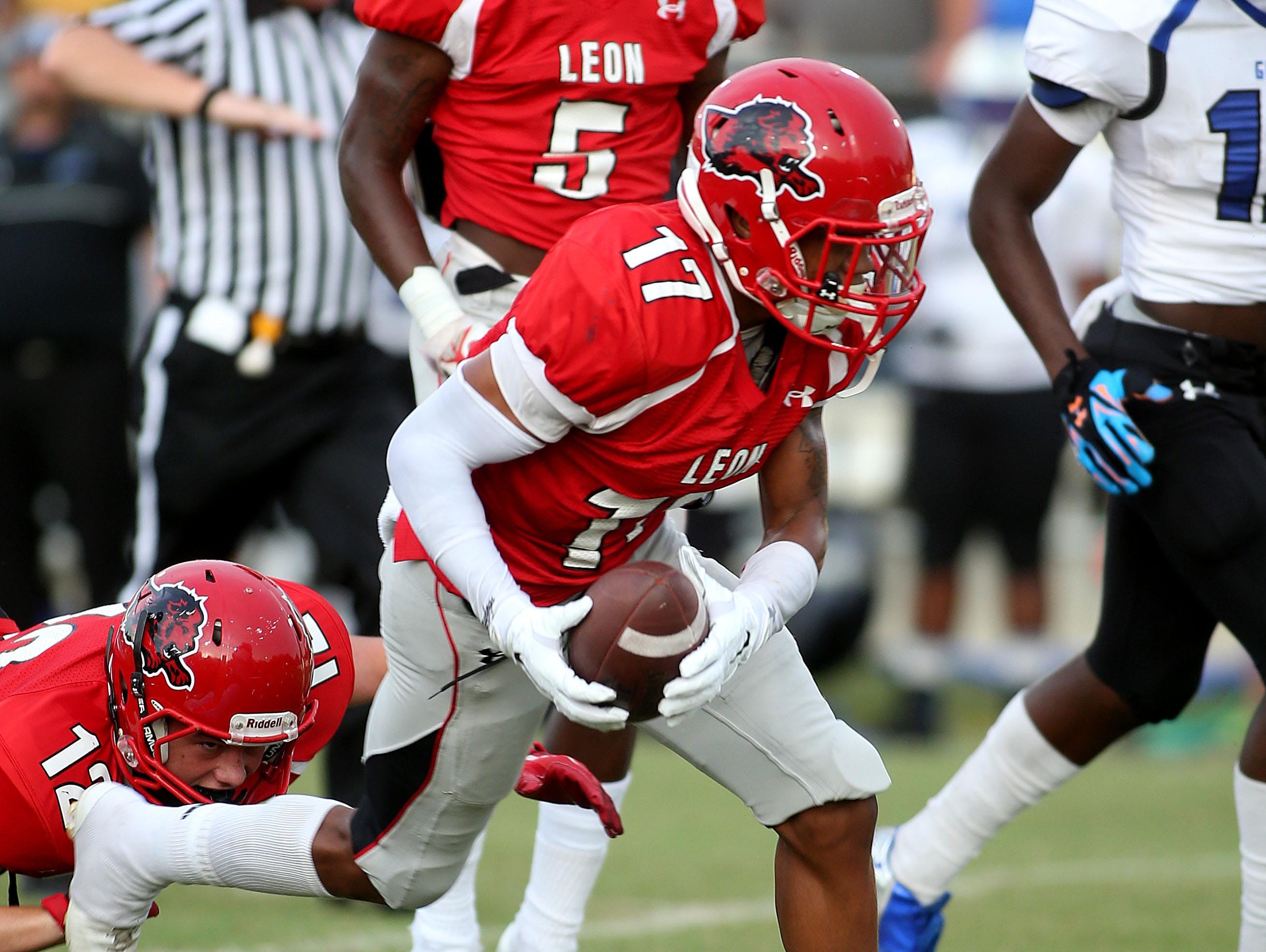 Leon's Damien Crumitie runs with the ball as the Godby Cougars roll past the Leon Lions at Gene Cox Stadium on Friday night.