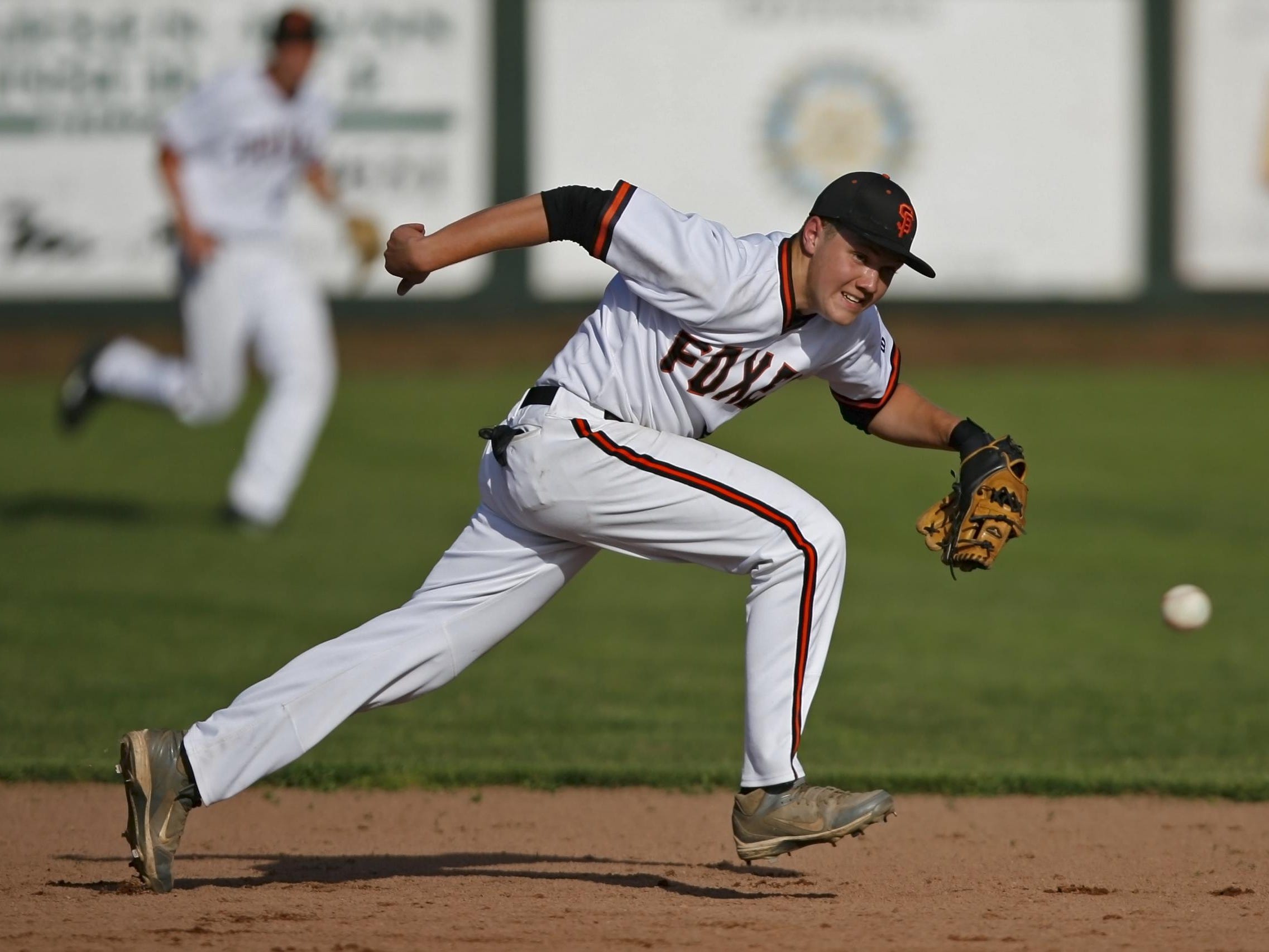 Silverton shortstop Grant Roth can't catch up with a ground ball up the middle in the top of the sixth inning of Silverton's 9-2 loss in a Mid-Willamette Conference baseball game, at Silverton, on Wednesday, Apr. 30, 2914.