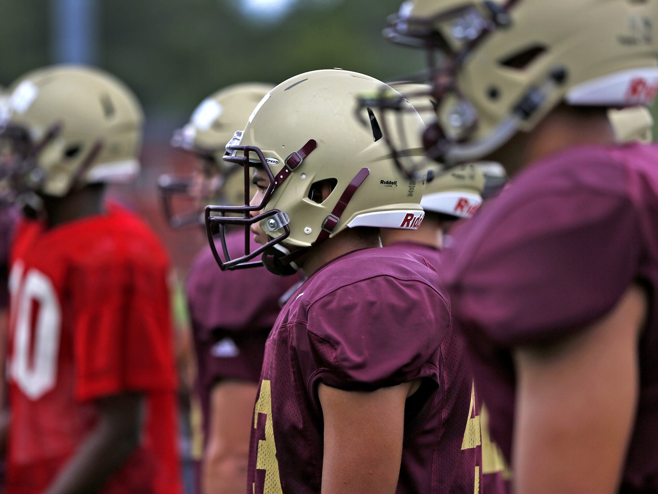 Brebeuf football players wear Riddell helmets with InSite impact monitoring system which monitors impacts as they occur for players.