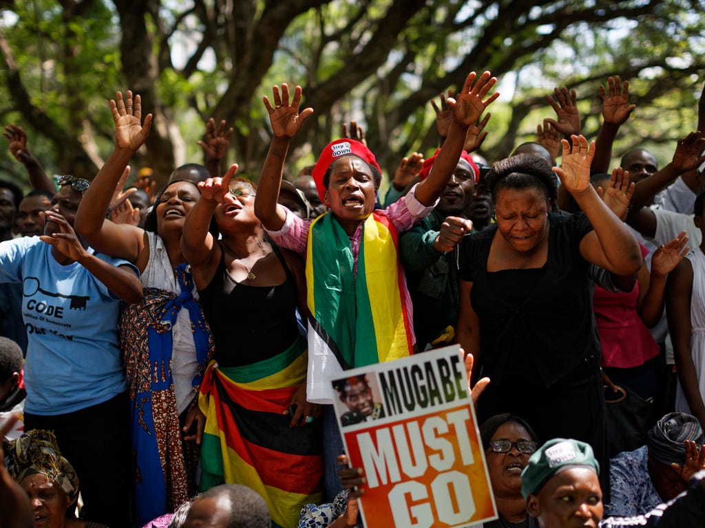 Protesters calling for the impeachment of President Robert Mugabe demonstrate outside the parliament building in Harare, Zimbabwe, Nov. 21, 2017.  Zimbabwe's political turmoil continues Tuesday as Parliament has begun impeachment proceedings against 