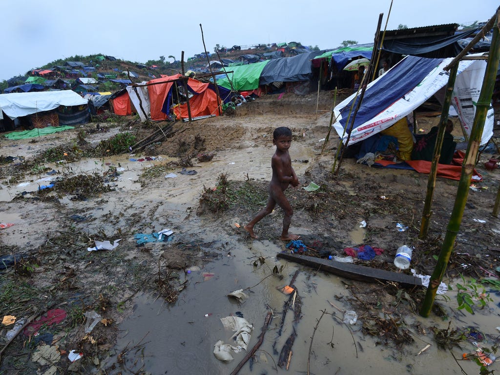 A Rohingya Muslim refugee child walks through Balukhali refugee camp near the Bangladesh town of Gumdhum on Sept. 17, 2017. Heavy monsoon rain heaped new misery September 17 on hundreds of thousands of Muslim Rohinyga stuck in makeshift camps in Bang