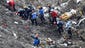 Rescue workers look over debris from the Germanwings