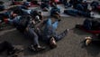 Demonstrators participate in a "die-in" in front of
