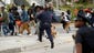 Baltimore Police officers chase protestors along Reisterstown