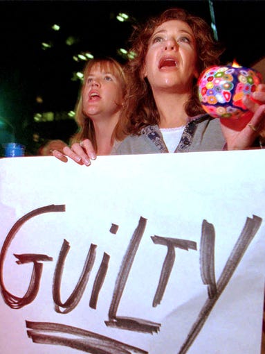 Brenda McKee, left, and Susan Sinai voice their feelings about the verdict outside the Federal Building on Wilshire Boulevard in Los Angeles.