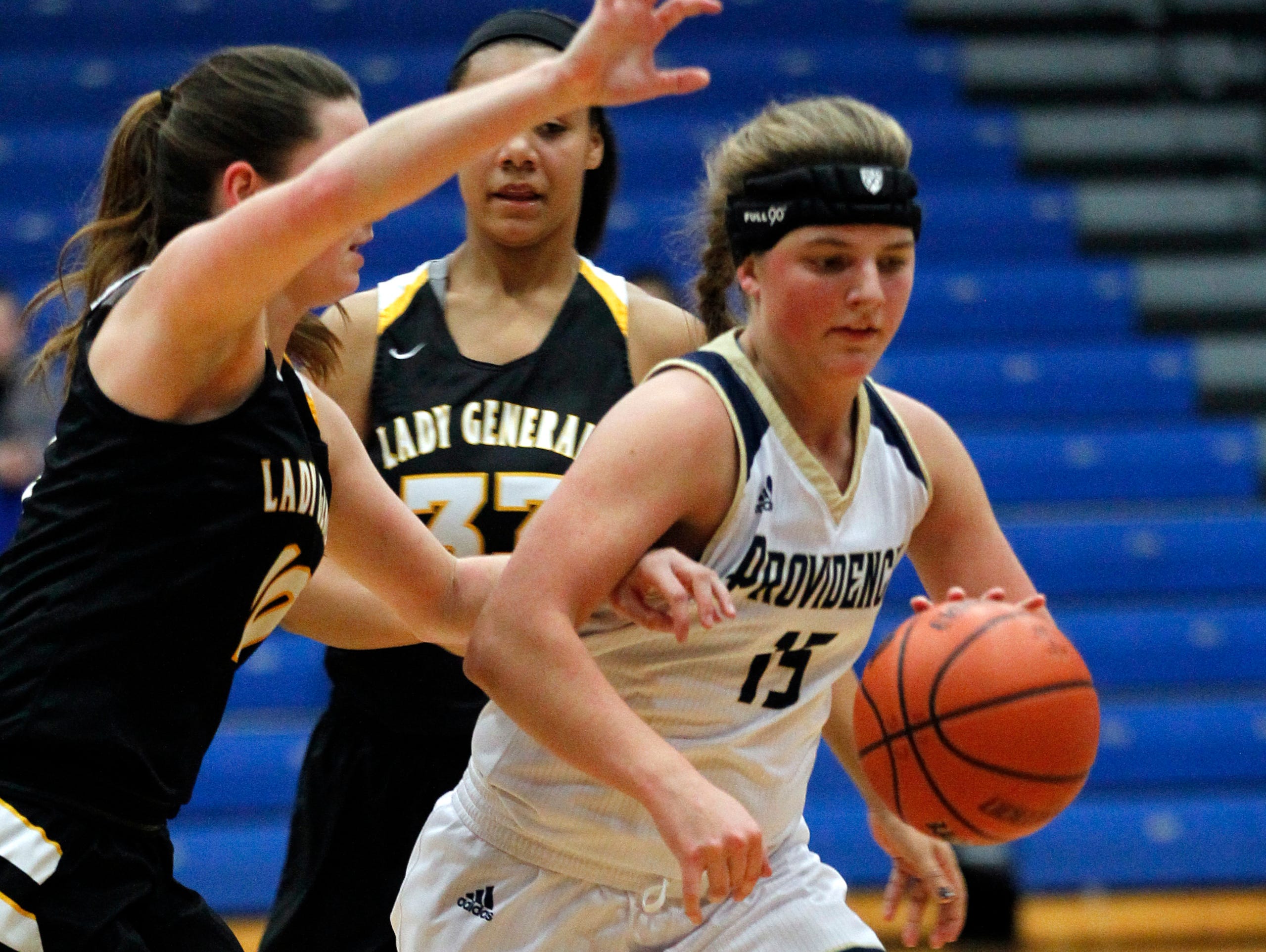 Providence High School's Hannah Wolford (15) fights pressure from Clarksville High School's Kayla Isgrigg (10) during their game at the Charlestown Girl' Basketball Holiday Tourney at Charlestown High School in Charlestown, Indiana. December 22, 2016