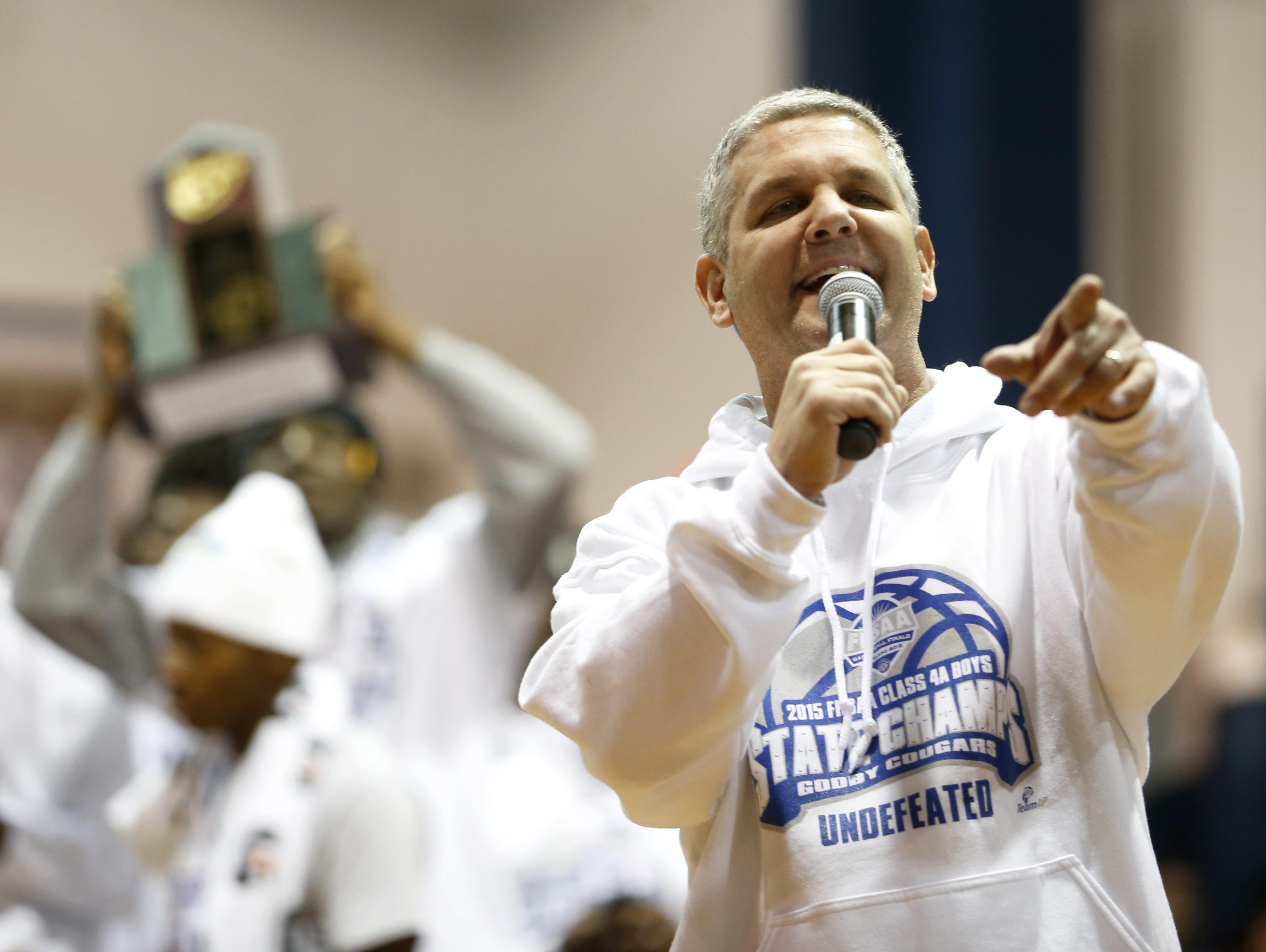 Godby coach Andy Colville speaks to the crowd of celebrators after the Cougars won a state title last season by going 31-0.