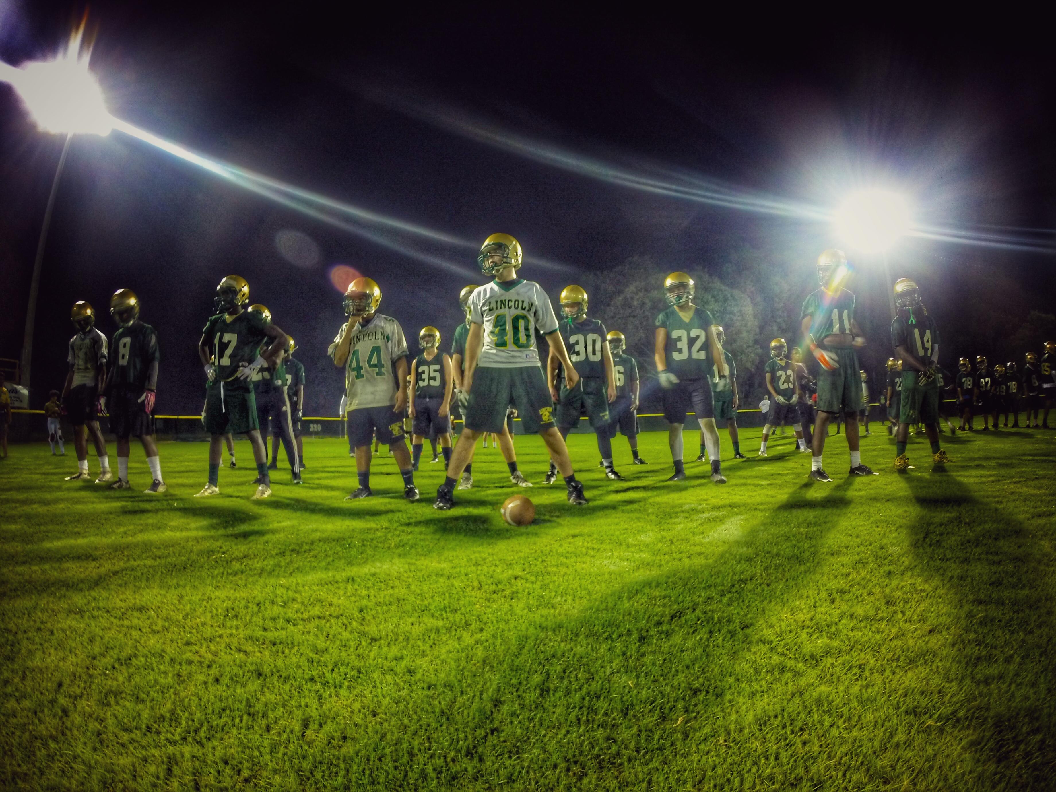 Lincoln’s special teams unit lines up in formation during drills for the Trojans’ 24th annual Midnight Madness practice.