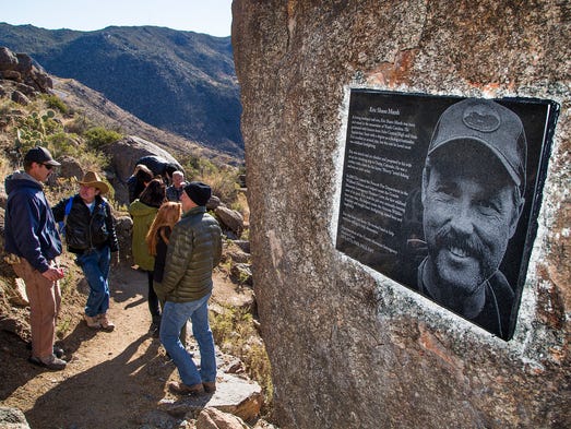 People stop while hiking up a trail after the dedication