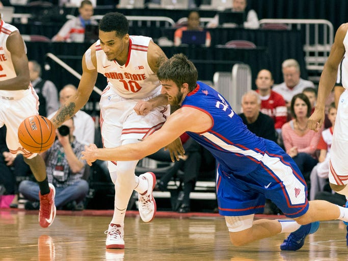 Ohio State Buckeyes forward LaQuinton Ross (10) gets to a loose ball ahead of diving American University Eagles center Tony Wroblicky (34) at the Schottenstein Center.