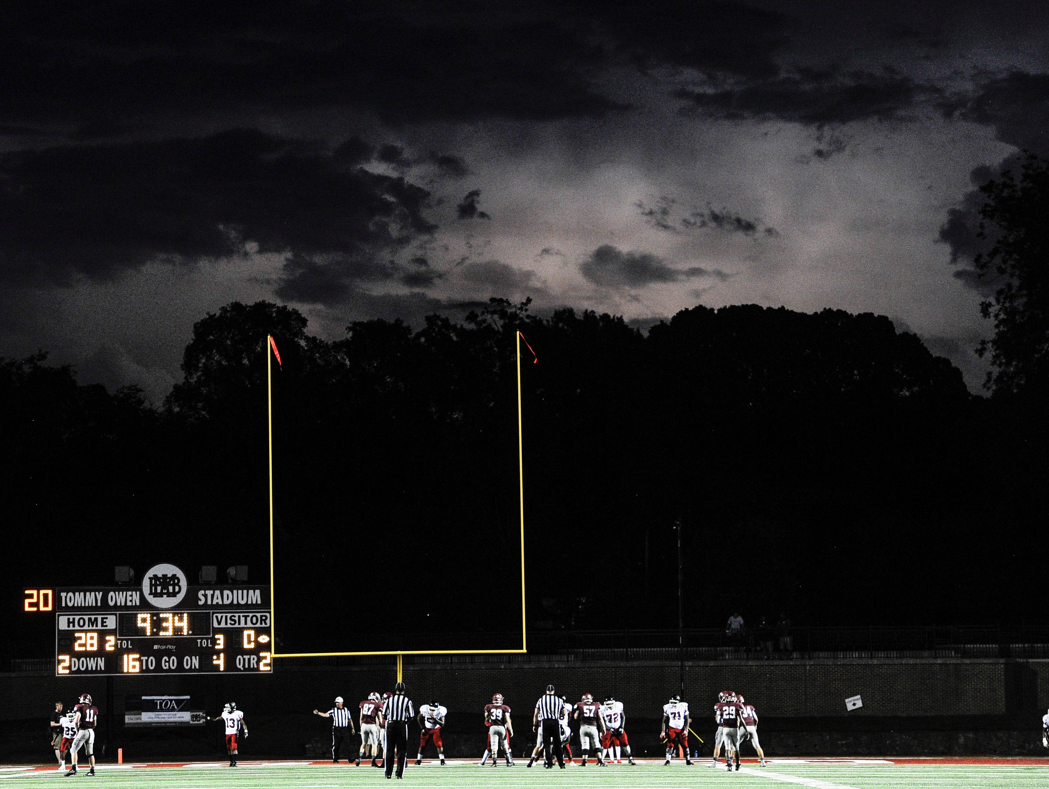 Lightning flashes in the sky as Pearl-Cohn and MBA play their game during the first half Friday. MBA won 49-7 with the game ending with 5:46 left in the third quarter due to lightning. Both coaches declared MBA the winner and it was not resumed.