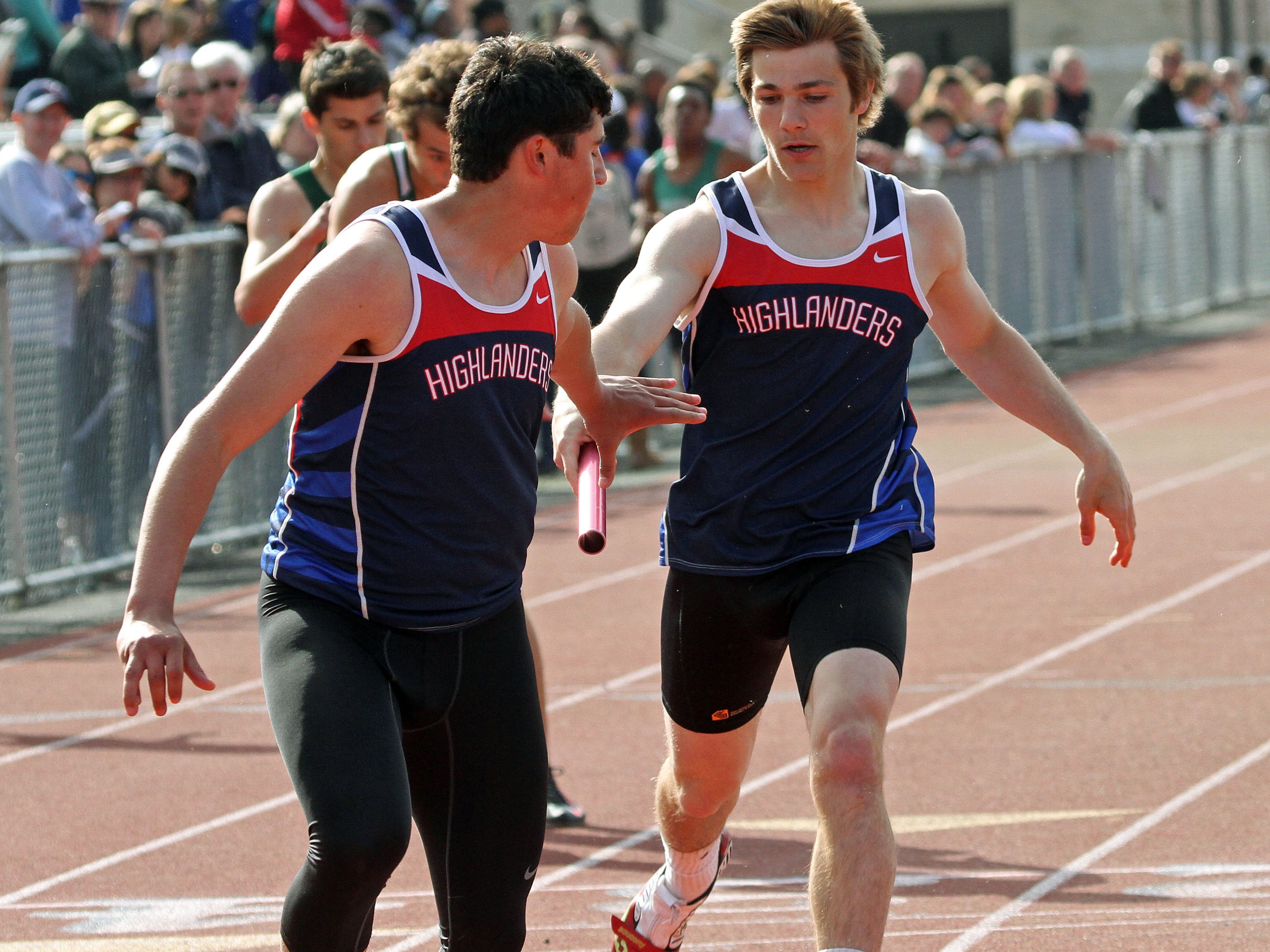 Governor Livingston's Nick DeLuca, right, hands off the baton to James Ruggiero during the 4x100. This is action of the Union County Track and Field Relays.