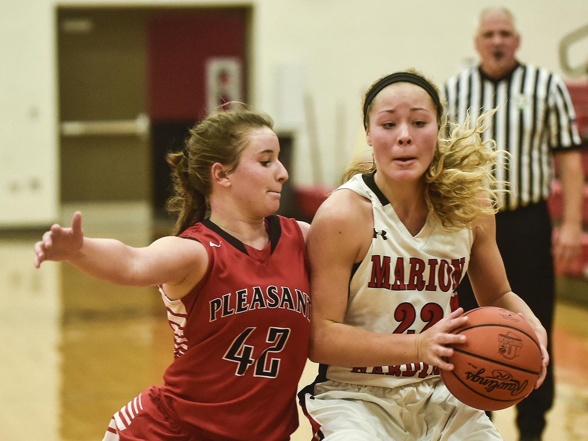 Marion Harding's Fallyn Stephens looks for a way around Pleasant's Jaden Mauk during the Marion Harding vs Pleasant basketball game on Friday.