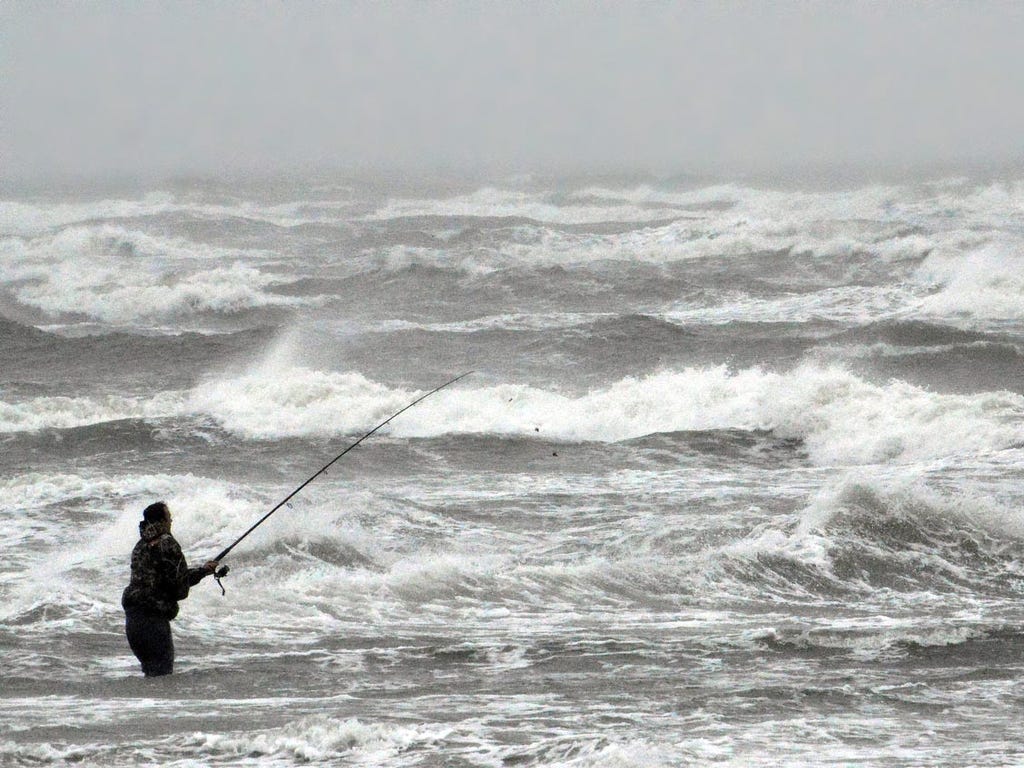 Luke Seymour of Canton, N.Y., braves 30-knot winds and heavy surf to try his luck fishing off the 2nd Avenue Beach in North Wildwood, N.J. Gov. Chris Christie declared a state of emergency before a storm expected to bring heavy rain and flooding.