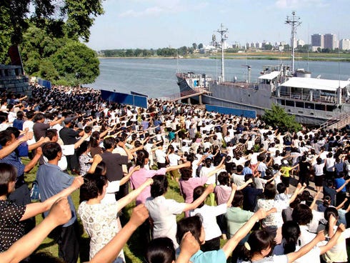 North Koreans raise their fists during a rally in 2010 in front of the U.S. Navy spy ship Pueblo, which was captured by North Korea in 1968.