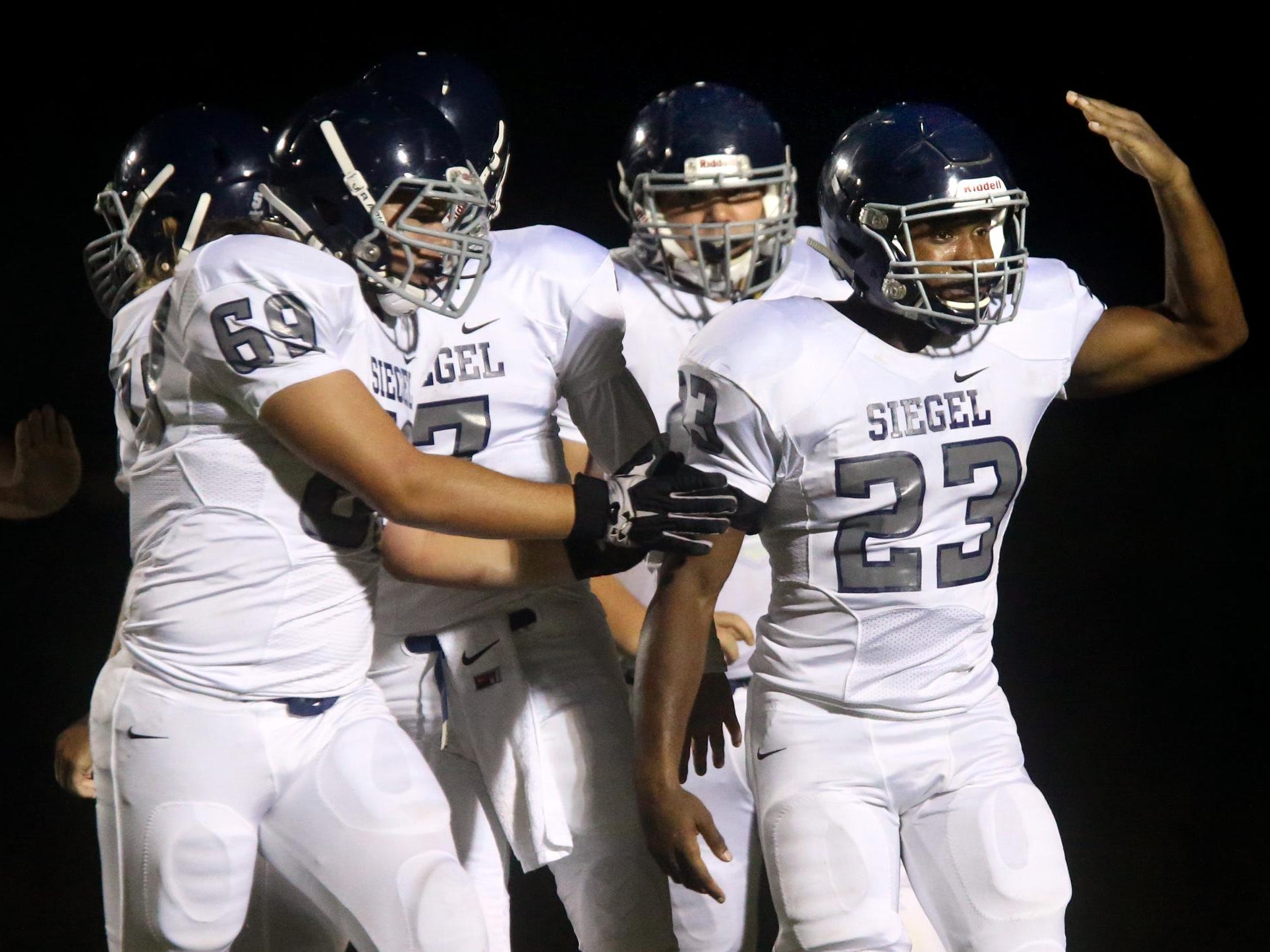 Siegel's Greedy Howse celebrates his first touchdown of the jamboree game against Summit on Friday at Stewarts Creek.