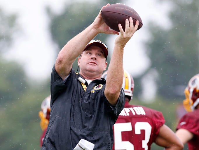 Jul 24, 2014; Richmond, VA, USA; Washington Redskins head coach Jay Gruden catches a ball during practice on day one of training camp at Bon Secours Washington Redskins Training Center. Mandatory Credit: Geoff Burke-USA TODAY Sports