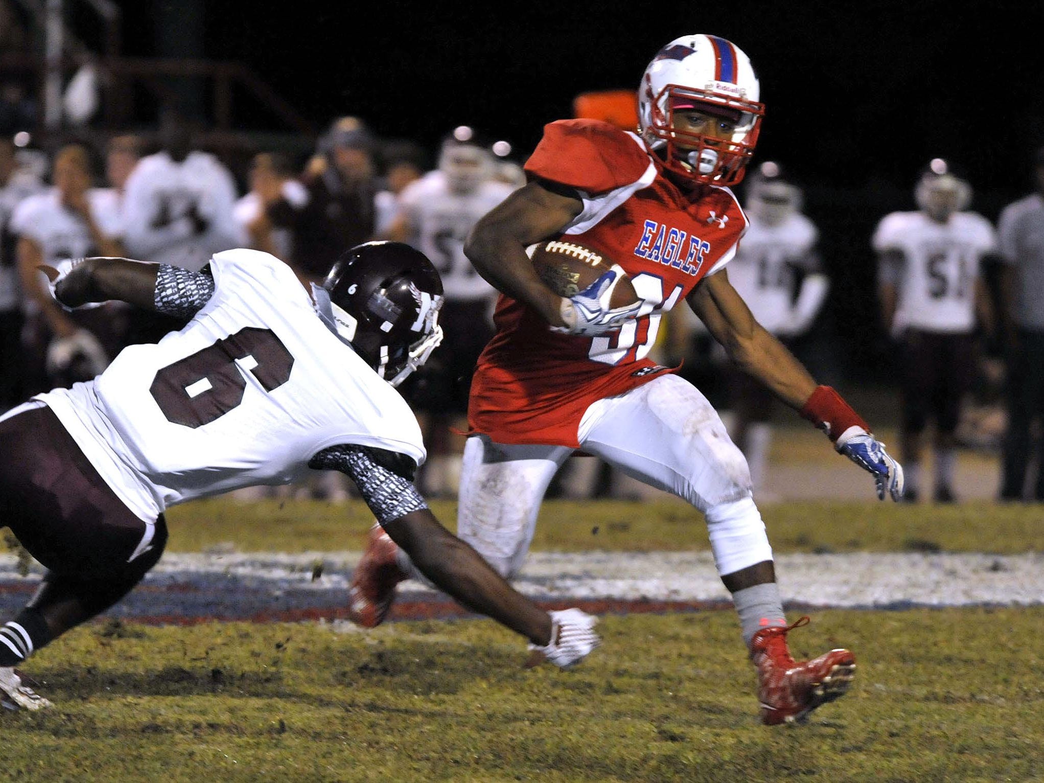 Devon Cooke of the Pine Forest Eagles manages to out maneuver Braijon Carr of the Niceville Eagles in first-half action in their game Friday night at Pine Forest High. However, Niceville went on to win the game 42-14.