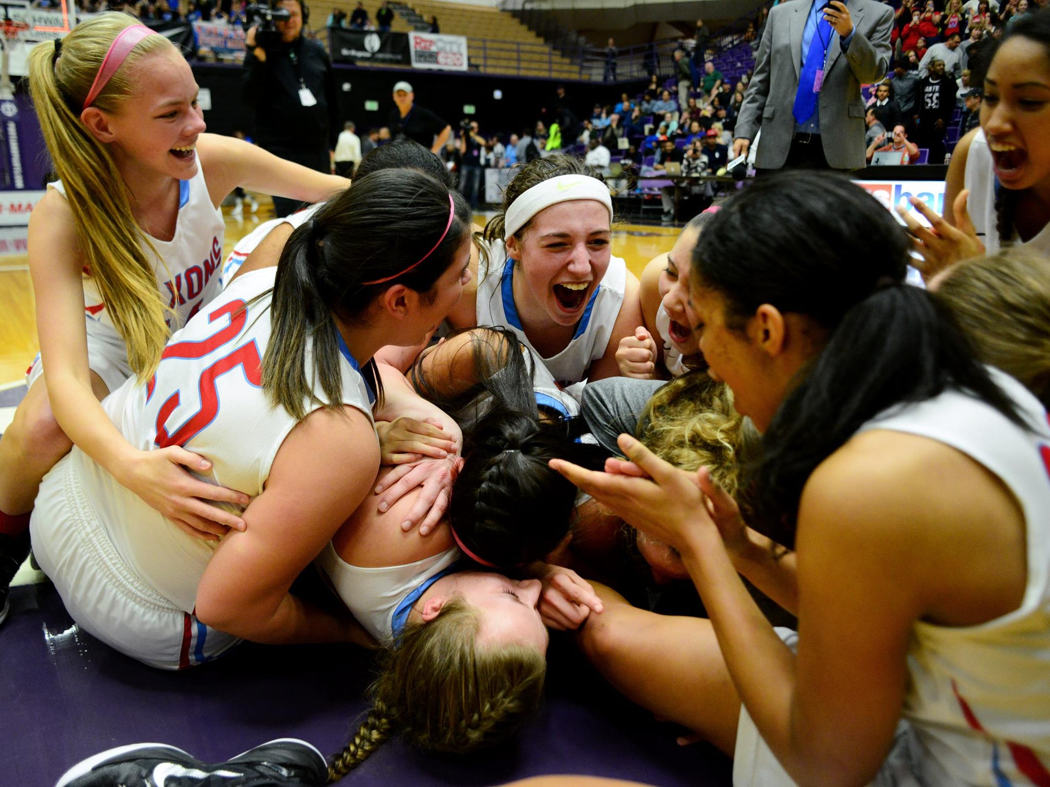 South Salem celebrates winning the championship game of the OSAA class 6A basketball tournament against St. MaryÕs inside the Chiles Center, on Saturday, March 14, 2015, at the University of Portland. South Salem won the game 56-50.