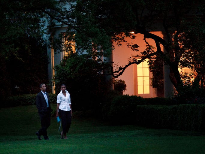 WASHINGTON - MAY 2: President Barack Obama (L) and First Lady Michelle Obama (R) take a short walk along the South Lawn past the West Wing of the White House after returning from a night out April 2, 2009 in Washington, DC. The couple went to dinner at Citronelle in Georgetown. (Photo by Brendan Smialowski/Getty Images)