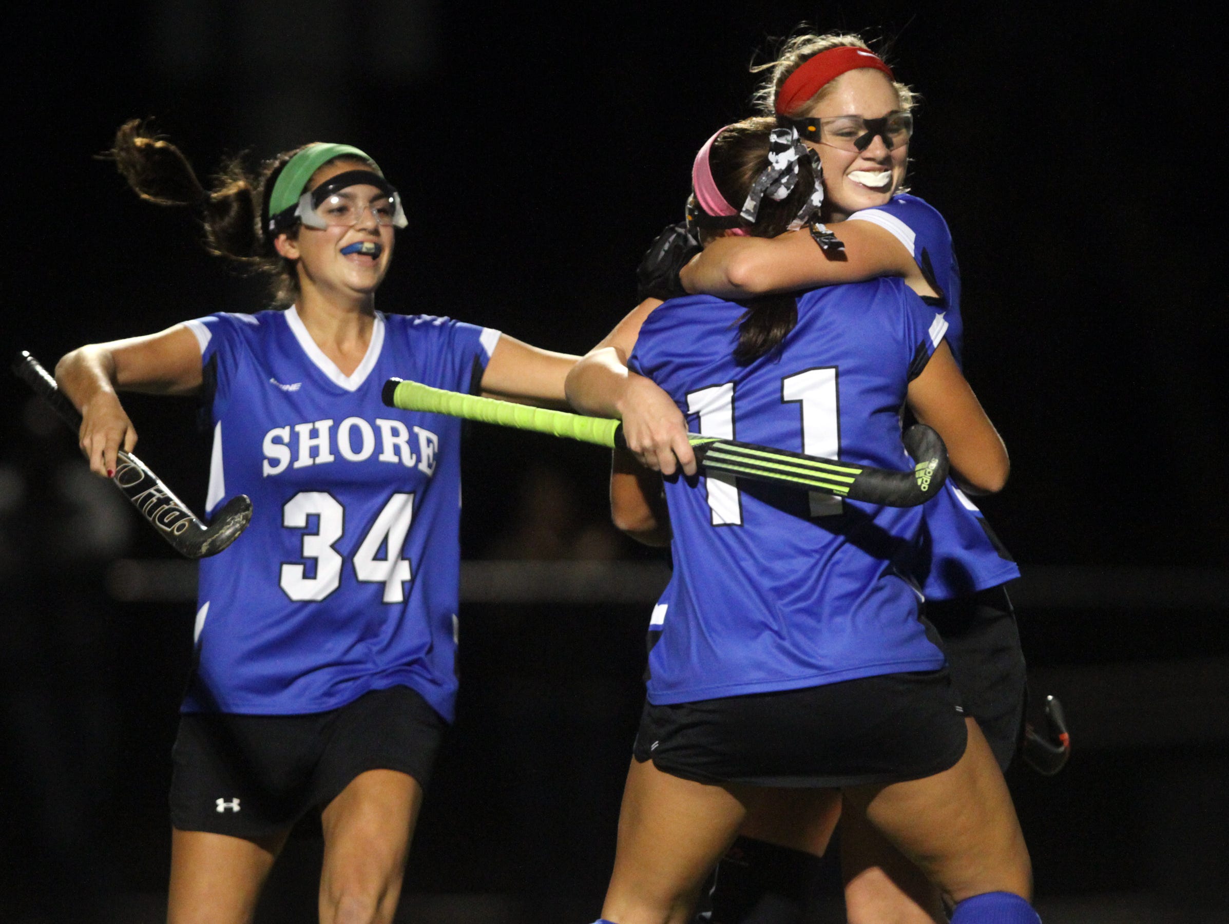 Shore Regional's Annie Deusch (11) celebrates a first half goal with teammates Jessica Welch and Kelsey O'Neill (34), Wednesday, November 11, 2015, at A.L. Johnson in Clark.