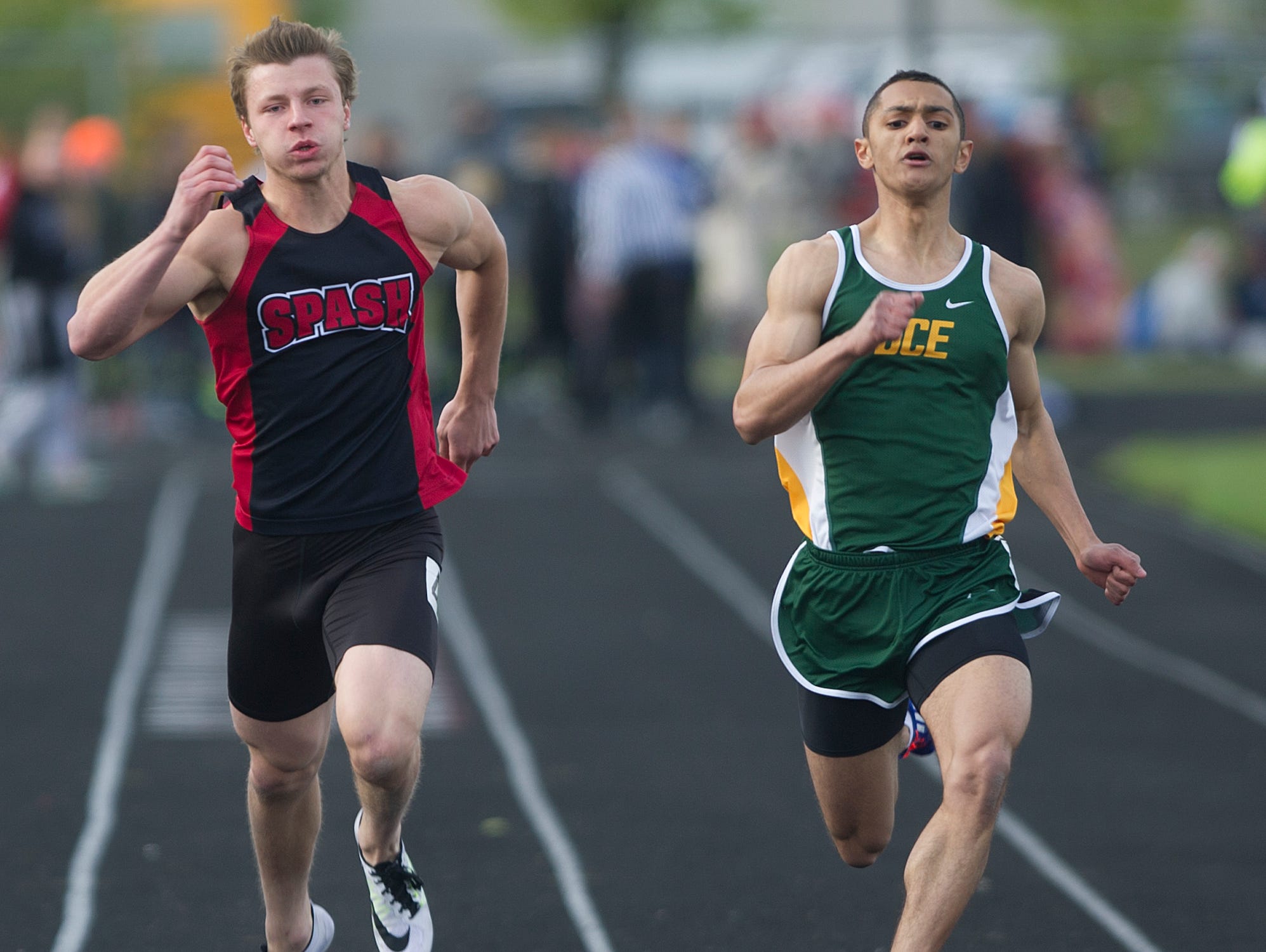 Stevens Point Area Senior High School's Victor Kizewski, left, and D.C. Everest's Deshawn Bryant, right, compete in the 100 meter dash the Wisconsin Valley Conference Track Meet at South Wood County Field in Wisconsin Rapids, Tuesday, May 19, 2015.