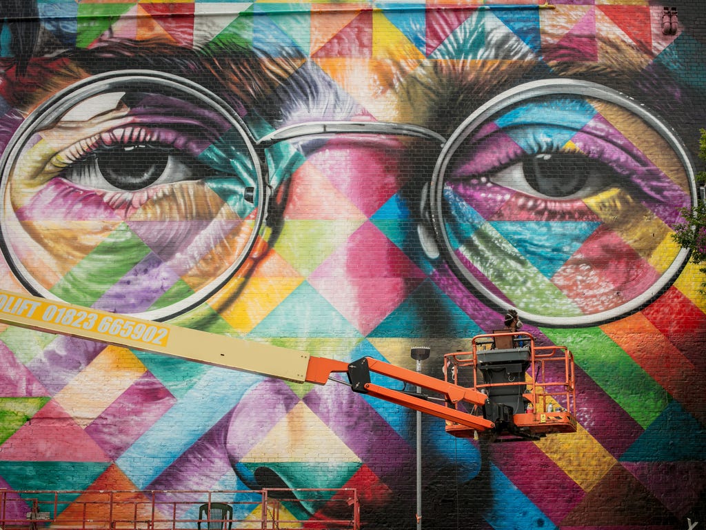 The finishing touches are made to a portrait of John Lennon by the Brazilian artist Eduardo Kobra on the final day of 'Upfest', Europe's largest street art festival in Bristol, England. The annual event, in the hometown of guerrilla artist Banksy, st