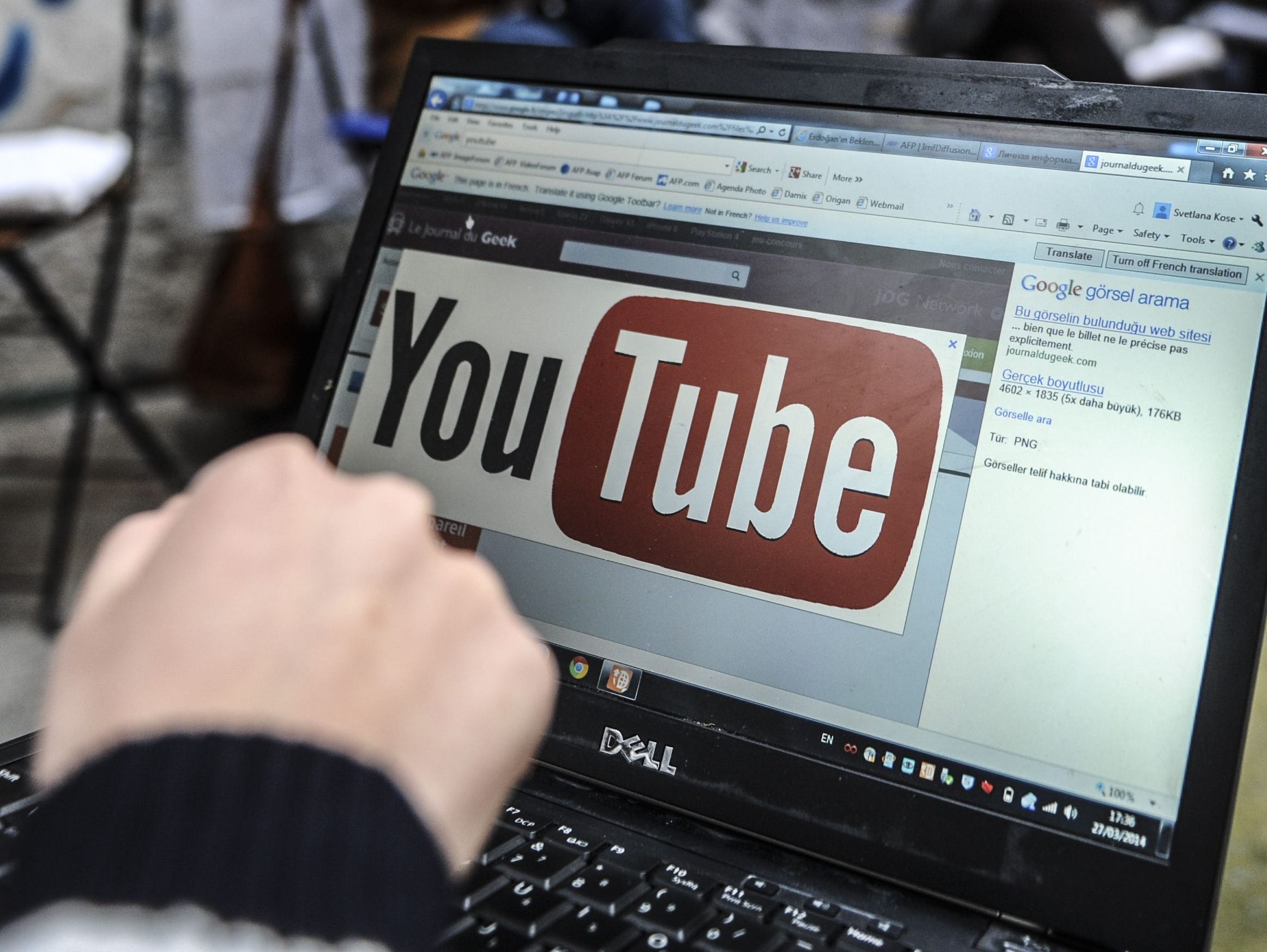 A file picture taken on March 27, 2014 shows a person using a laptop computer showing Youtube's logo in Istanbul.