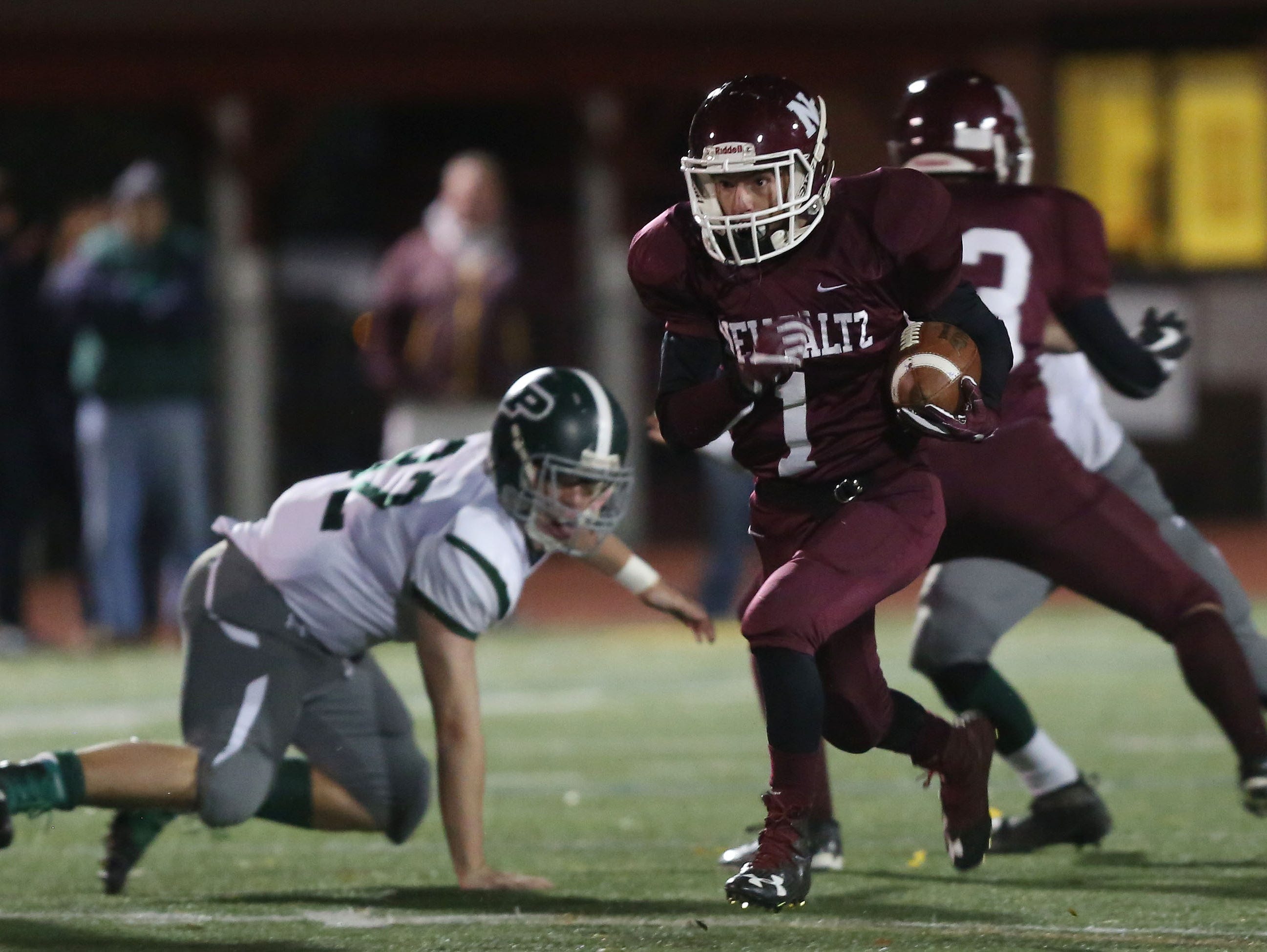 New Paltz's Hunter McVea (1) breaks a tackle as he runs 61 yards for a first quarter touchdown against Pleasantville in the Class B regional semifinal football game at Dietz Stadium in Kingston Nov. 11, 2016