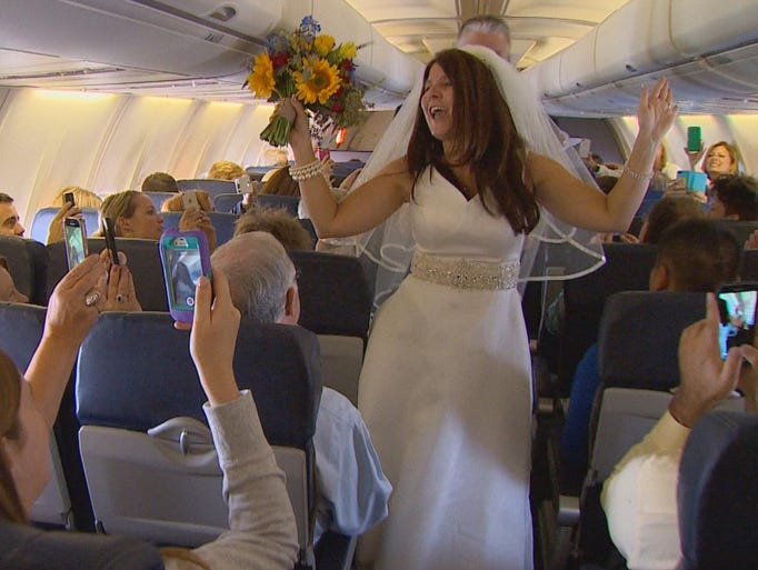 Dottie Coven dances down the aisle of a Southwest Airlines