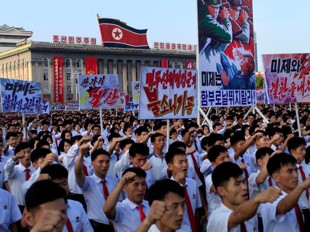 Tens of thousands of North Koreans gathered for a rally at Kim Il Sung Square carrying placards and propaganda slogans as a show of support for their rejection of the United Nations' latest round of sanctions on Aug. 9, 2017, in Pyongyang, North Kore