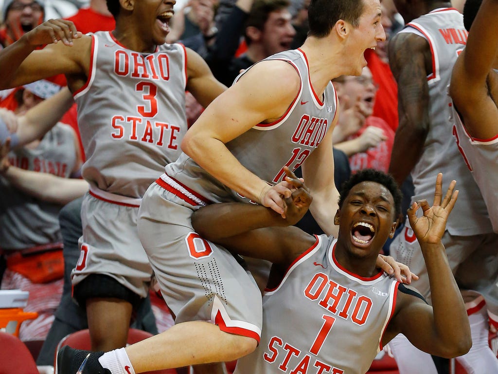 Ohio State Buckeyes forward Jae'Sean Tate (1) and guard Andrew Dakich (13) celebrate as the Buckeyes pull away from the Maryland Terrapins during the second half at Value City Arena.