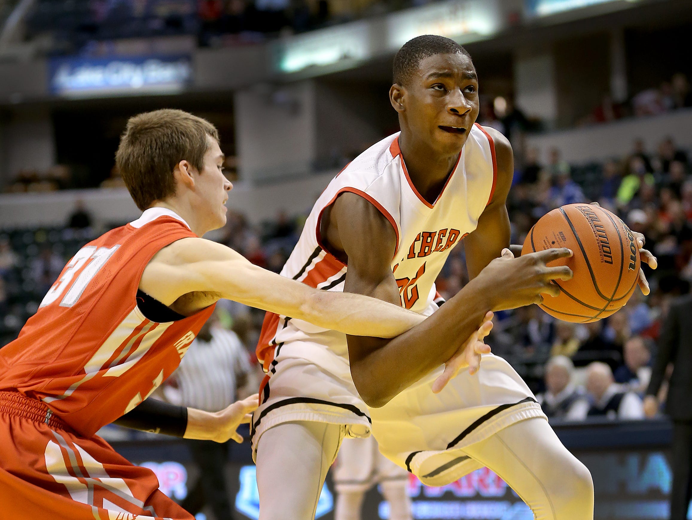 Park Tudor's Jaren Jackson Jr., is fouled by Frankton's Austin Compton,left, during their ISHAA 2A State Championship game. The Park Tudor Panthers defeated the Frankton Eagles 73-46 to win the IHSAA 2A Boys Basketball State Final Saturday, March 28, 2015, at Bankers Life Fieldhouse.