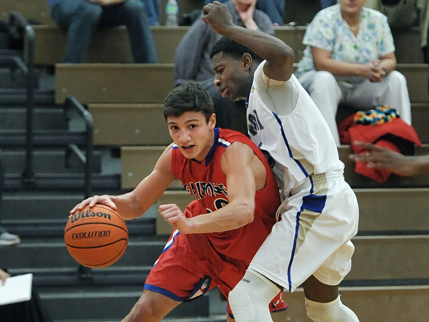 Fairport's Dan Masino ducks under the pressure of Webster Schroeder's Marique Simkin.