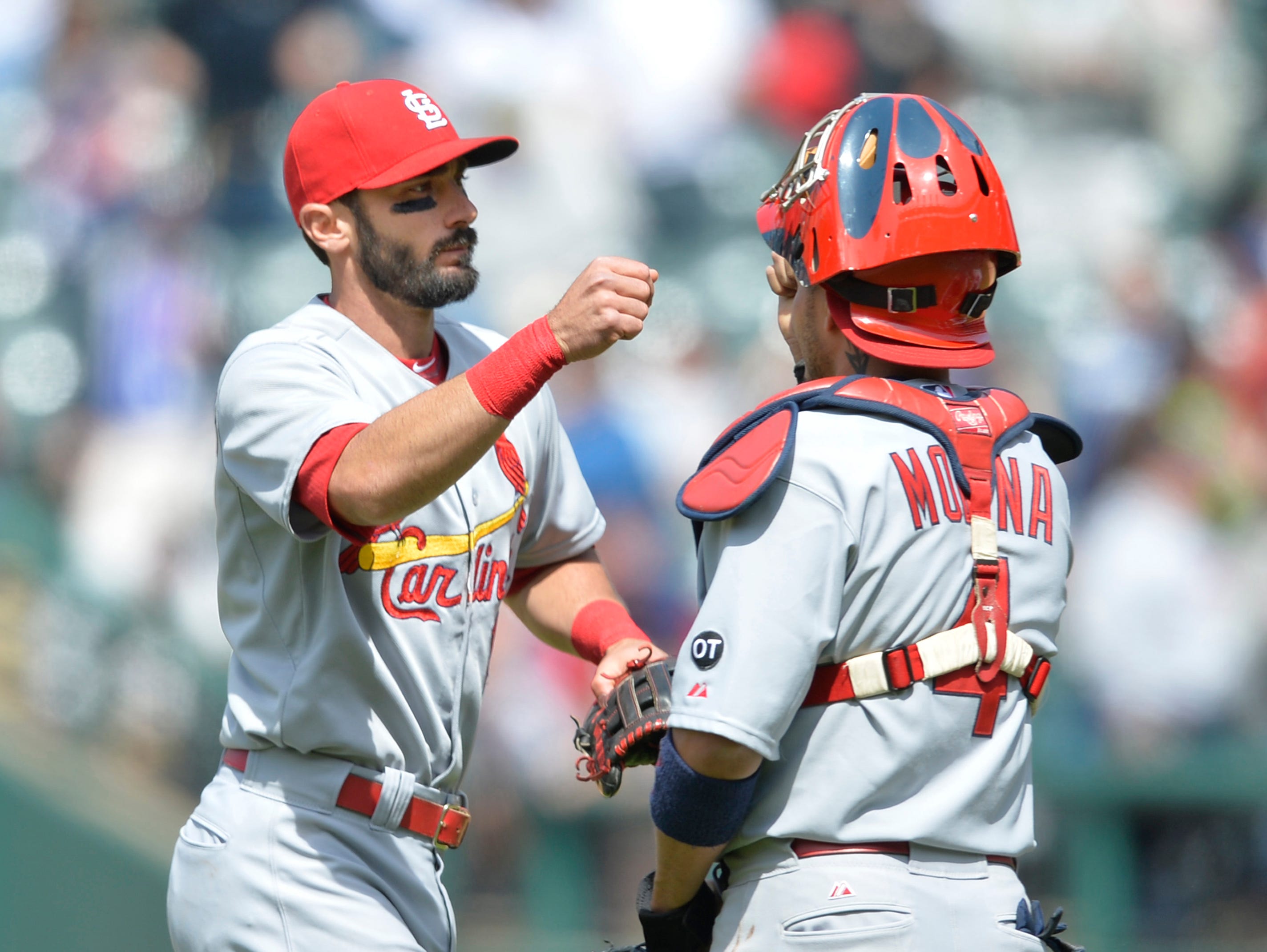May 14, 2015; Cleveland, OH, USA; St. Louis Cardinals third baseman Matt Carpenter (13) celebrates with catcher Yadier Molina (4) after a 2-1 win over the Cleveland Indians at Progressive Field. Mandatory Credit: David Richard-USA TODAY Sports