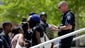 A member of the Federal Protective Service asks demonstrators to stay off the steps leading to the Thomas F. Eagleton federal courthouse during a protest in St. Louis. About 100 protesters marched from city hall to the courthouse as they continue to press for broader reforms to local and federal law enforcement following the shooting death of Michael Brown by police.