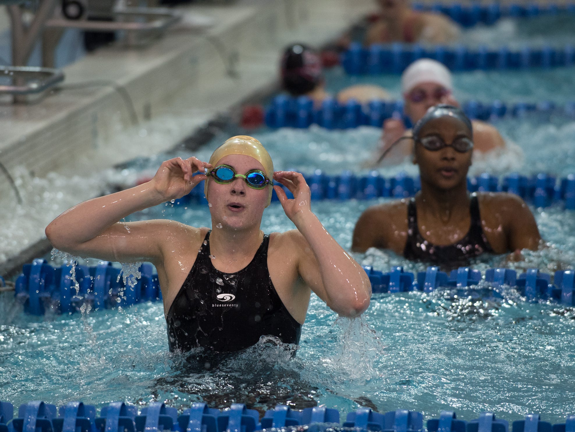 Delaware Military Academy's Kelly Blake looks at the score board after competing in the 50 yard freestyle final at the girl's DIAA swimming and diving championships at the University of Delaware.