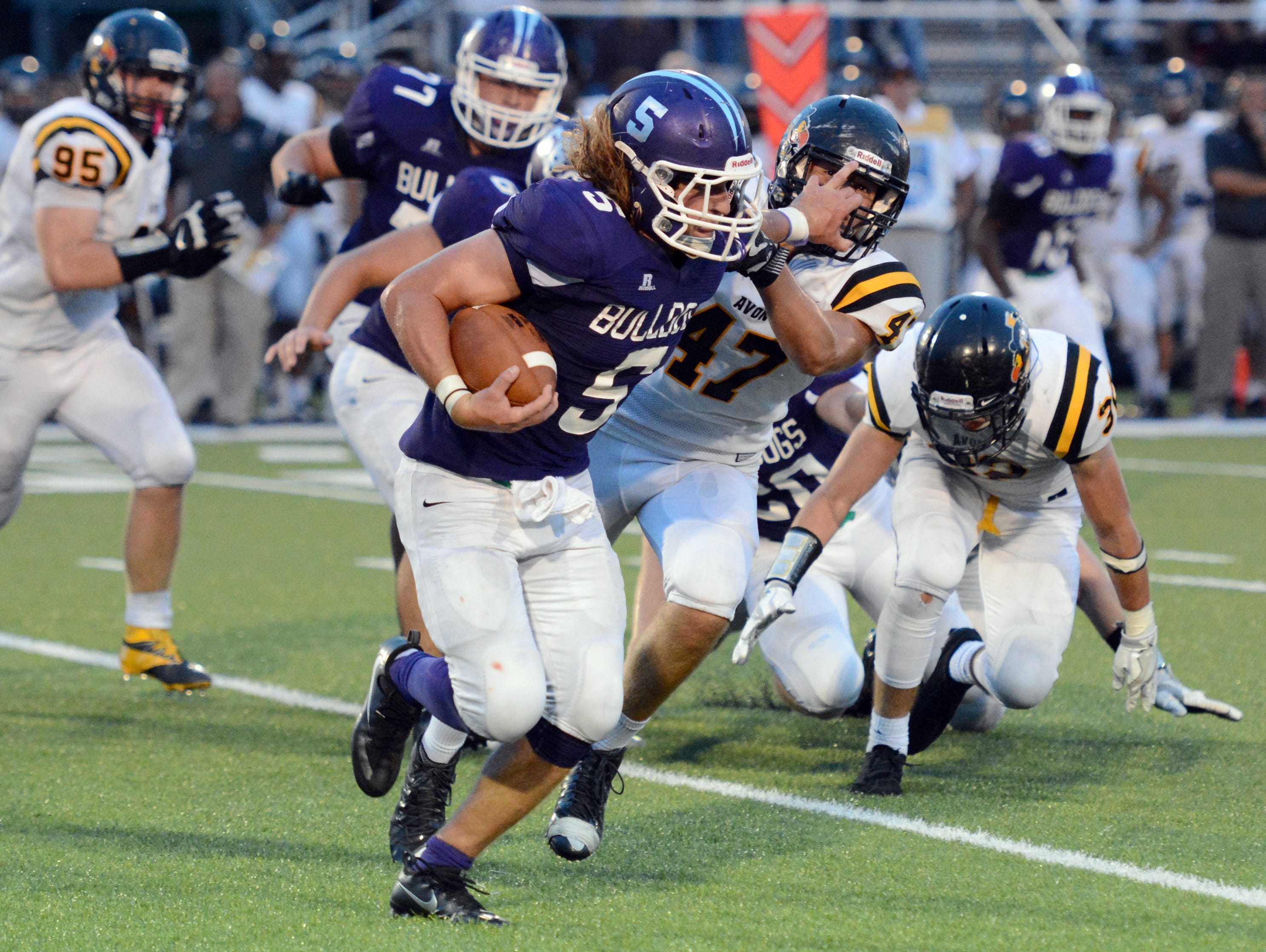 Brownsburg's Carson Gill tries to keep an Avon defender at bay Friday night.