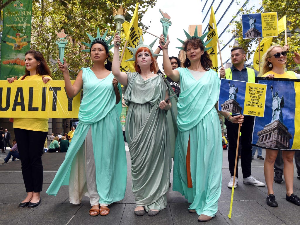 Women wearing Statue of Liberty costumes protest\u000d\u000aPresident Trump's immigration policies in Sydney, Australia on March 9, 2017.