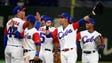 March 7: Outfielder Victor Mesa of Cuba (2nd R) celebrates