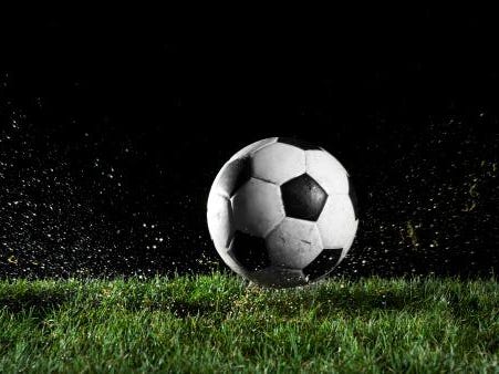 Soccer ball in motion over grass