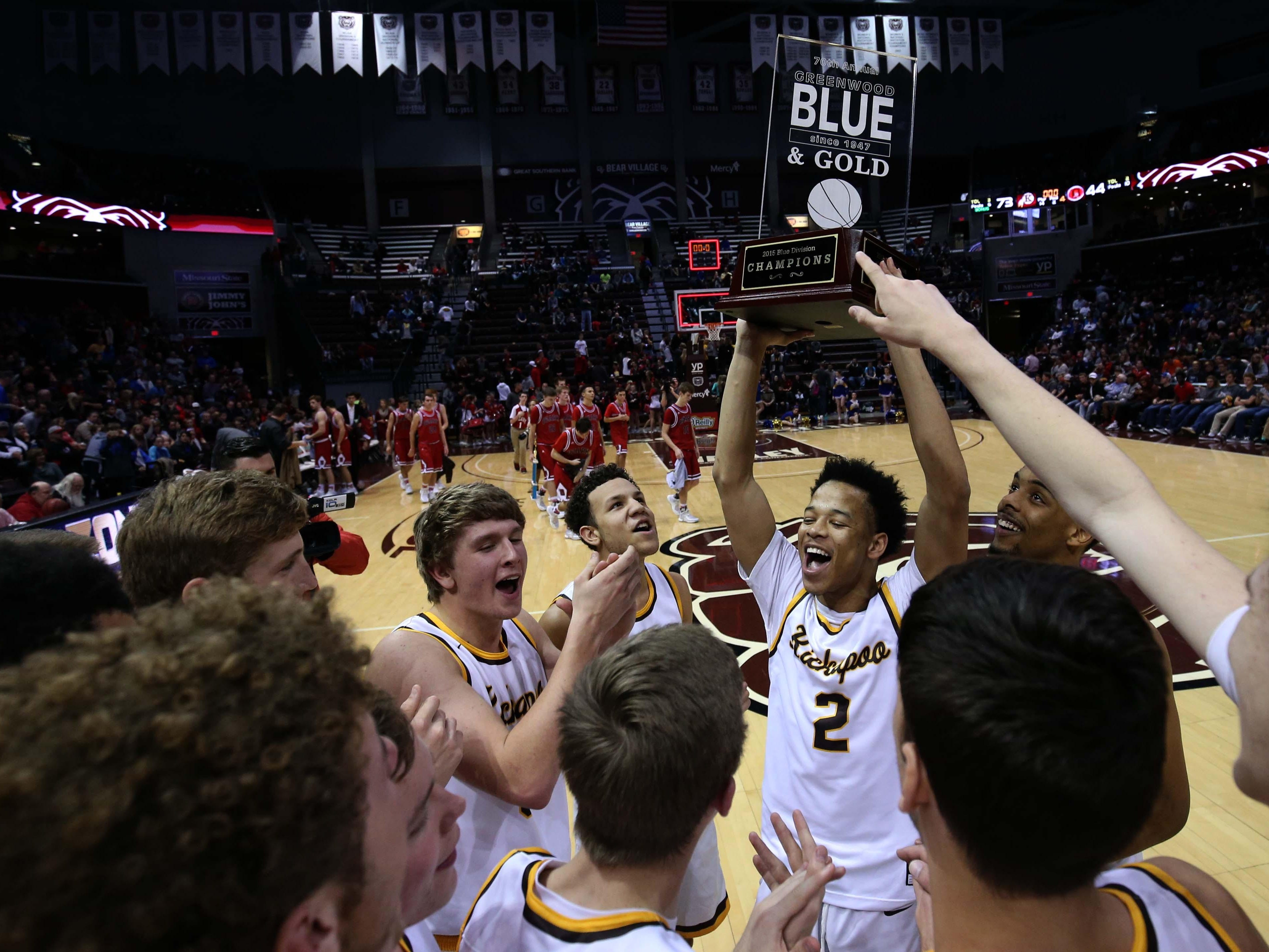 Kickapoo's Derrick Roberson hoists the championship trophy after beating Ozark in the Blue Division Final at JQH Arena on Wednesday night.