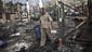 A man walks through a destroyed pro-Morsi camp at Rabaa al-Adawiya Square in Cairo.