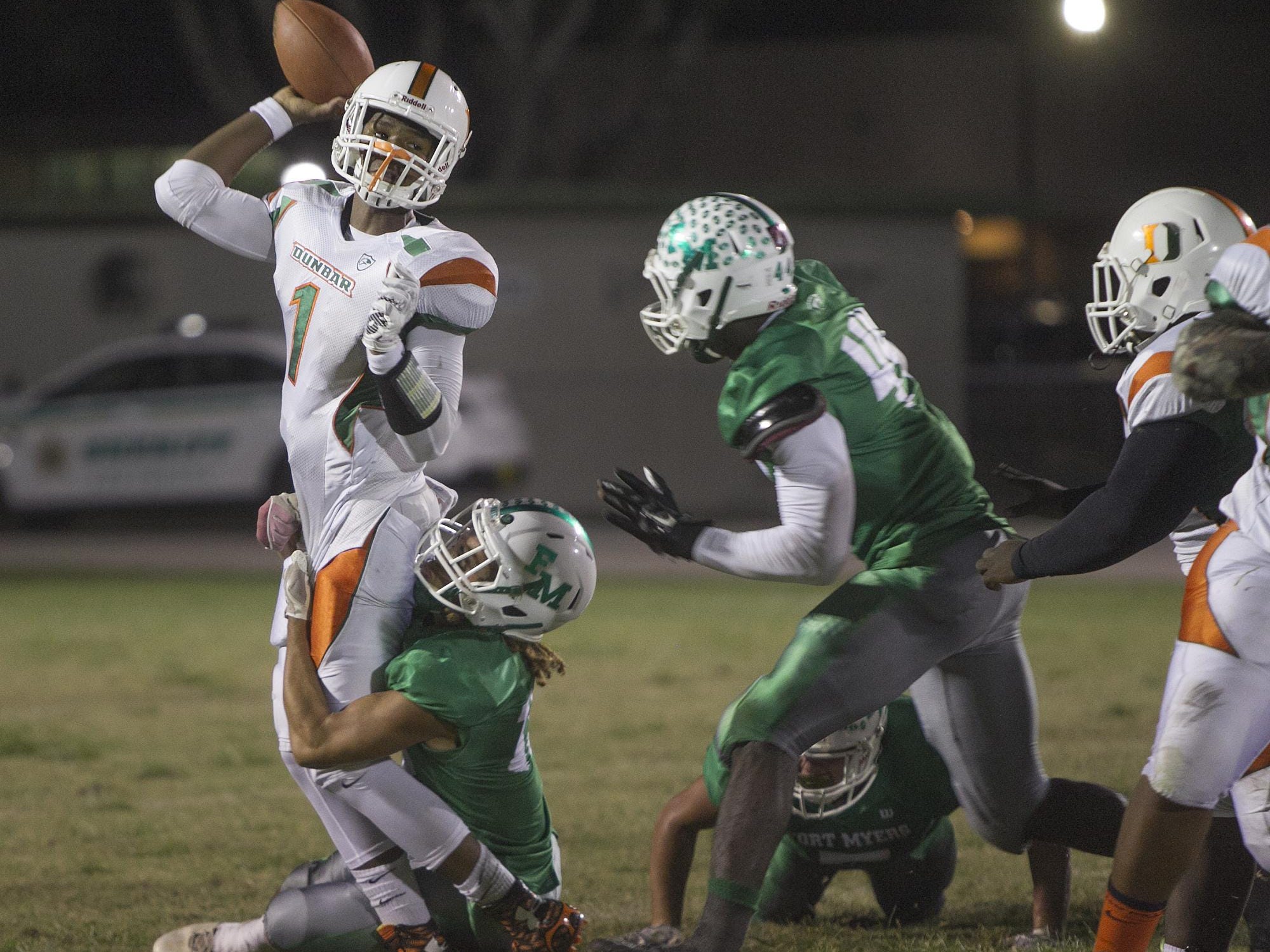 Dunbar QB Jairus Johnson is wrapped up by Fort Myers defender Eddie Ferguson Friday at Sam Sirianni Field in Fort Myers. The pass was incomplete.